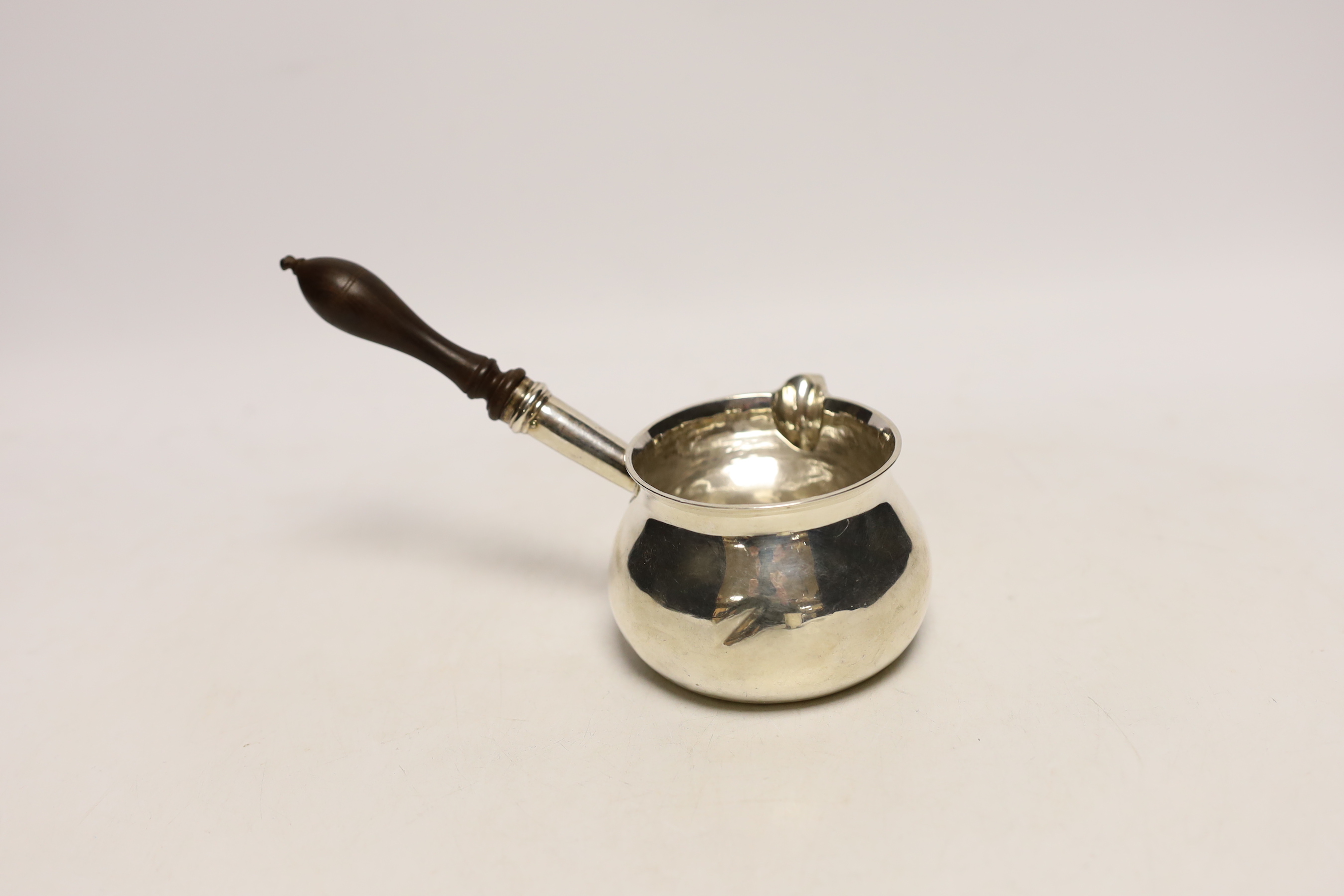 A George III silver brandy warmer, with turned wooden handle, Charles Chesterman II, London, 1786, length 17cm, gross weight 4.3oz.